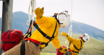 Photo of rappellers coming down off of a rappel line from a helicopter.