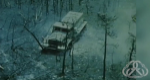 A view from overhead of a burned fire truck in the middle of a burned fire area.