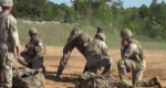 Five army soldiers ready a rocket launcher.