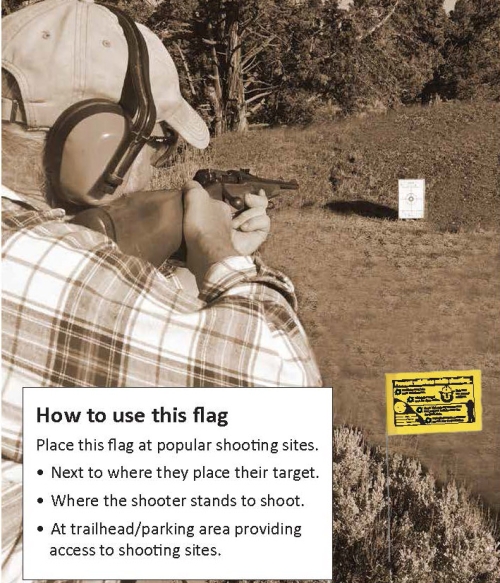 Man shooting with flag in ground next to him